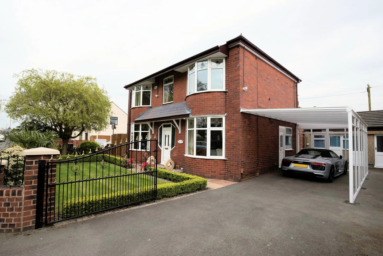 Harbour carport on a contemporary UK home with block paving