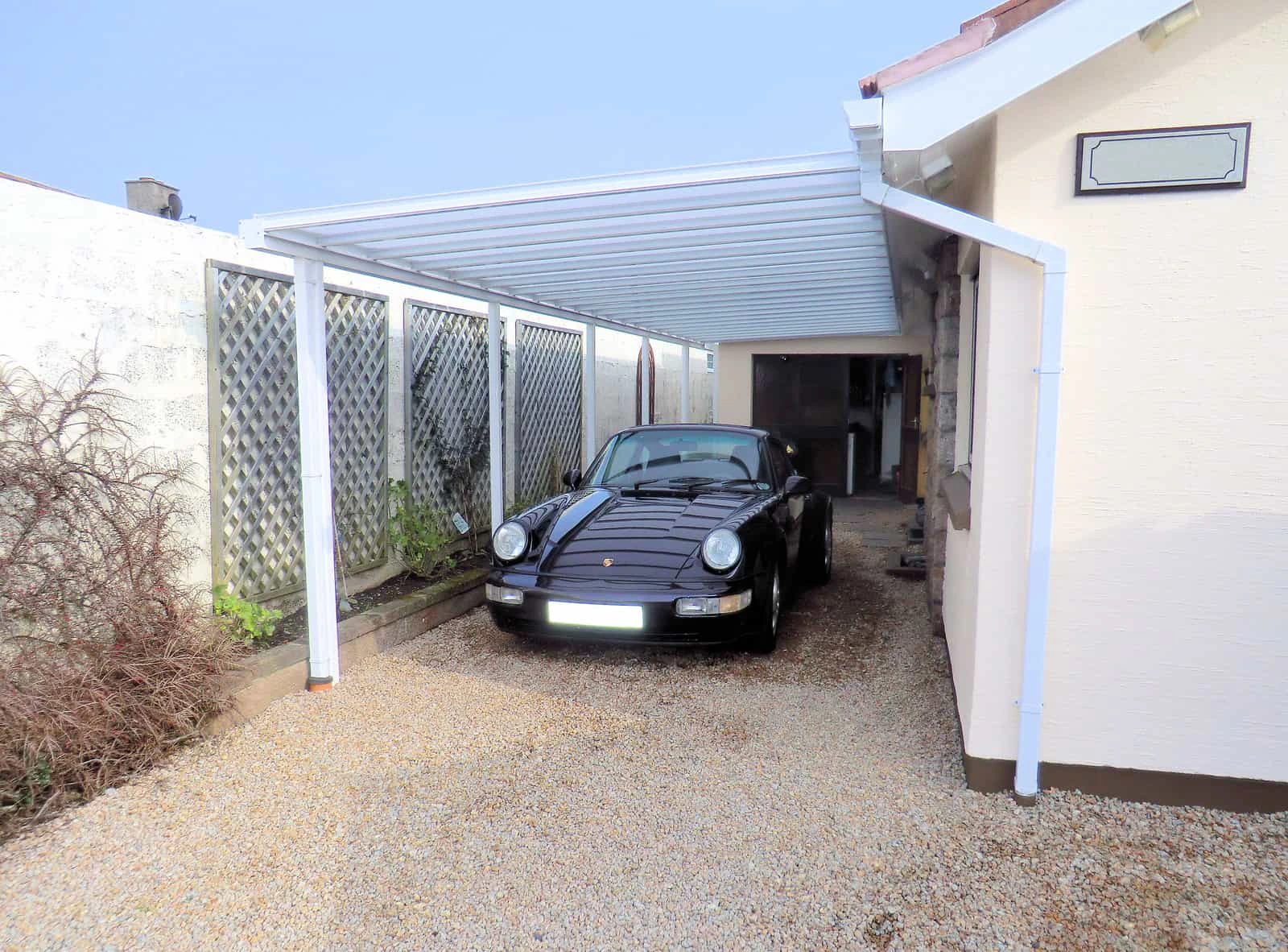 Harbour carport side view showing frame and polycarbonate roof