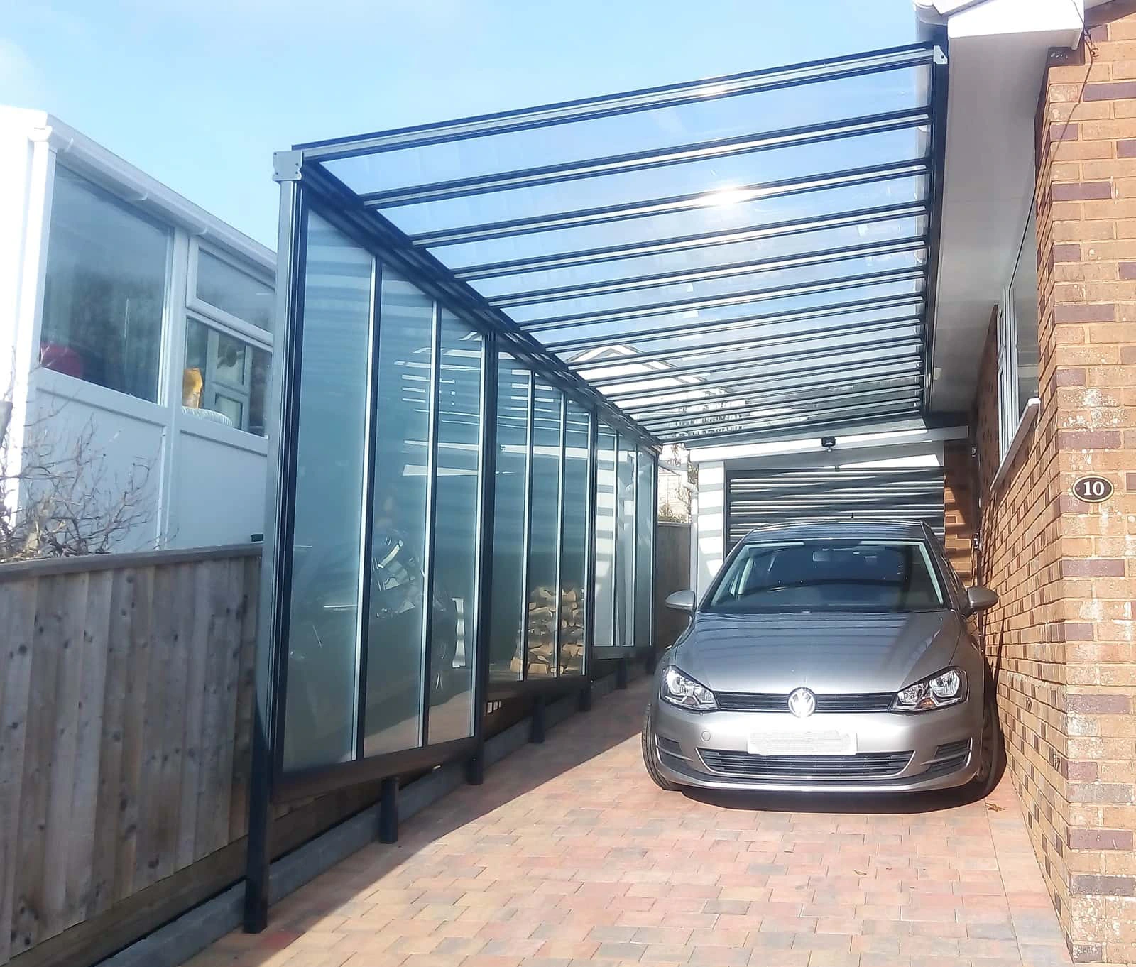 Harbour carport wide view fitted to a UK family home driveway